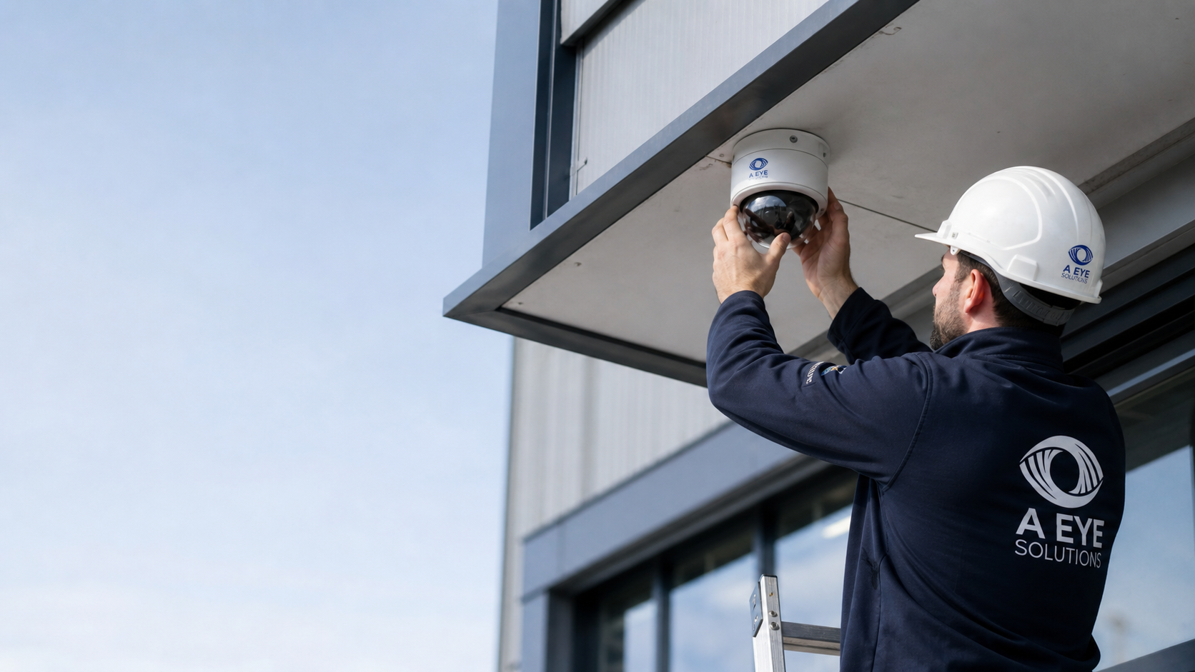 A Eye Solutions engineer installing a commercial CCTV dome camera